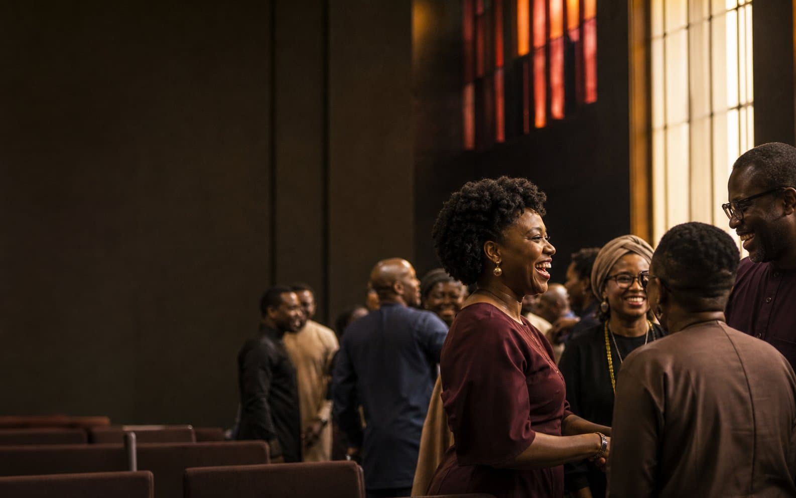 Members of the Shekinah Family Church community sharing a joyful moment after service